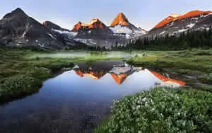a mountain range reflected in a lake