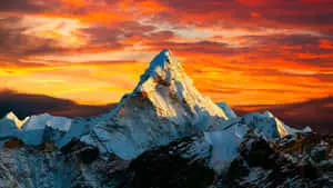 a mountain with a red sky and a cloud