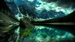 a mountain lake with clouds and rocks