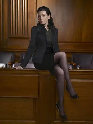 Julianna Margulies Posing Elegantly on a Wooden Countertop