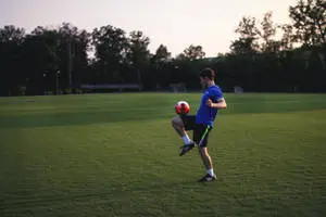Man In Football Field With Football HD
