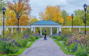 a garden with a gazebo and flowers