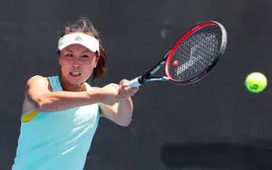 Shuai Peng shining in bright sunlight during a professional tennis match