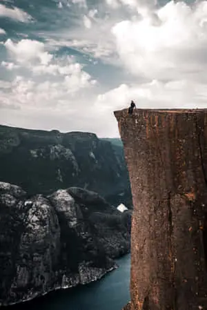 a person is standing on a cliff