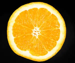 Vibrant Orange Slice Against Black Background